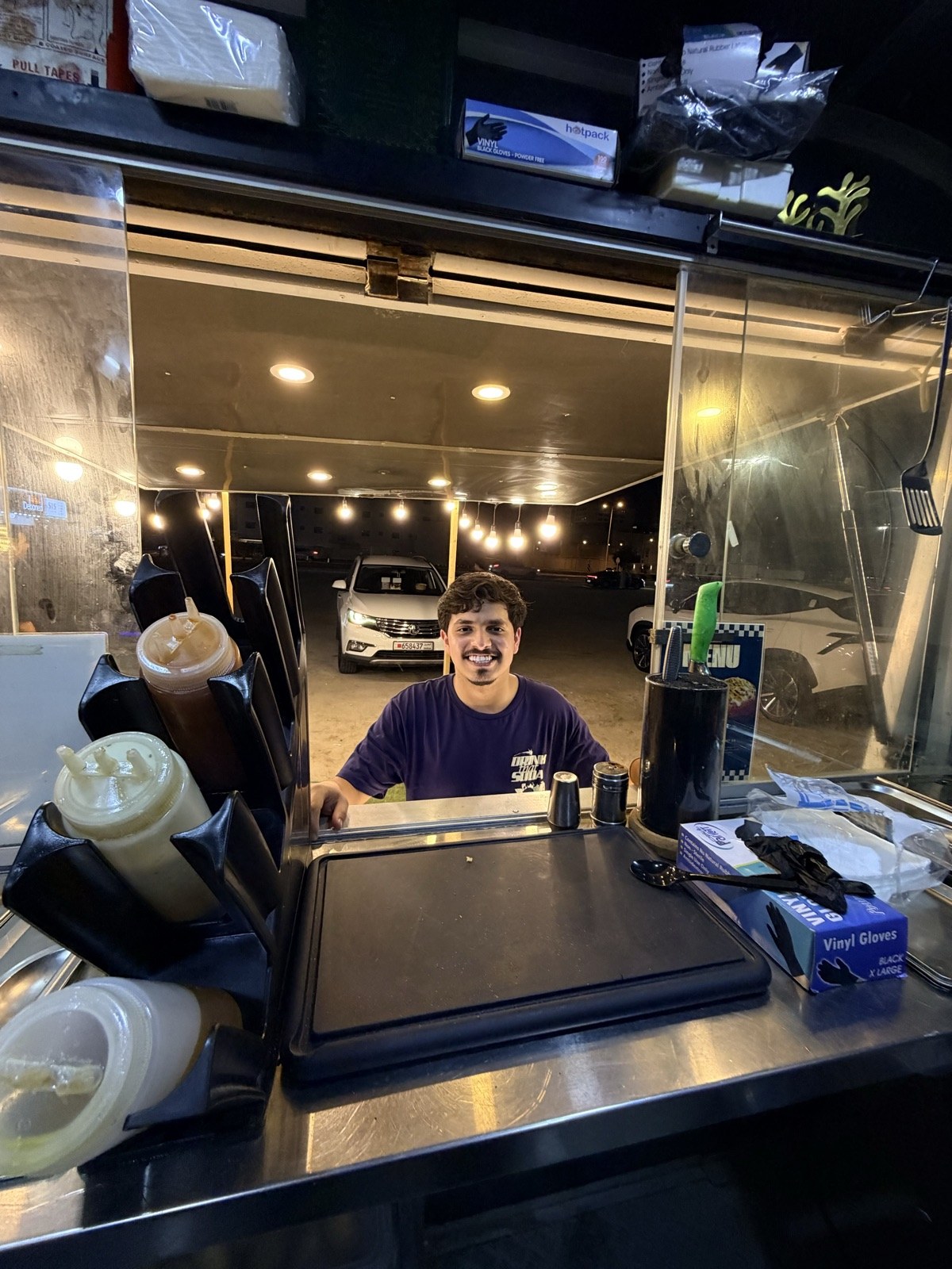 A smiling Spudlicious team member at the truck